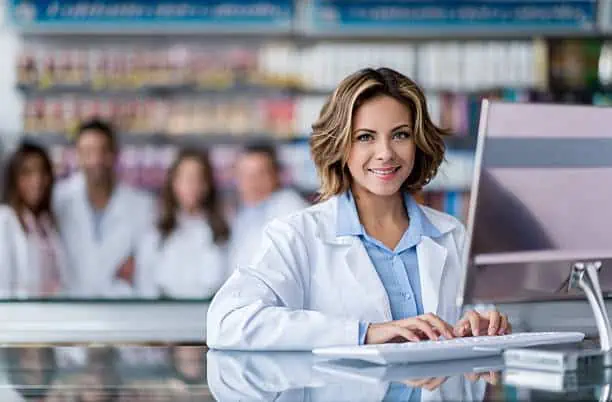 Cashier woman at the pharmacy typing on the computer