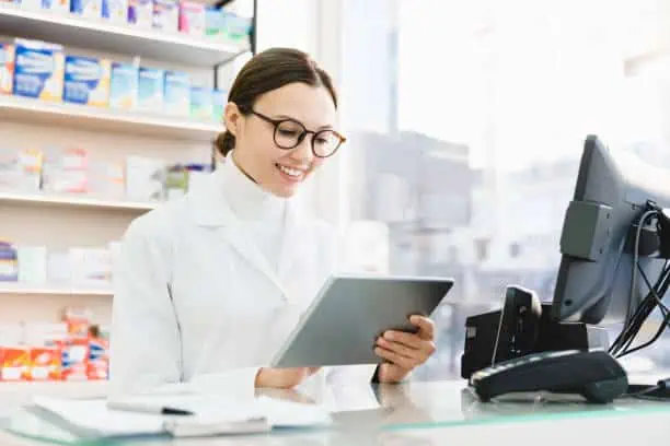 A pharmacist looking at the tablet