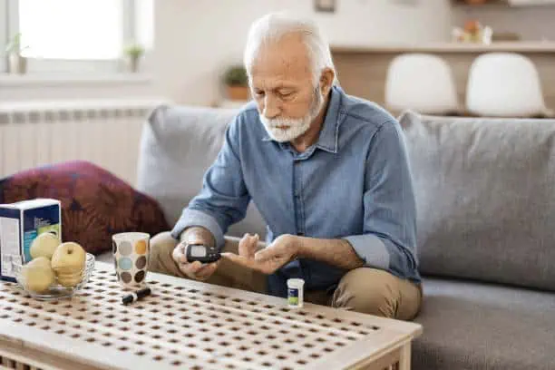 Senior Man With Glucometer Checking Blood Sugar Level at Home. Diabetes, Health Care Concept