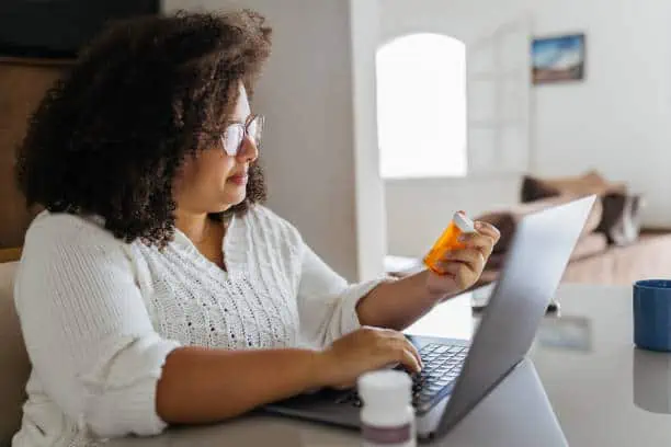 Woman ordering medicine online on laptop
