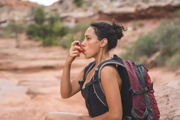 A girl carrying her inhaler while on hike