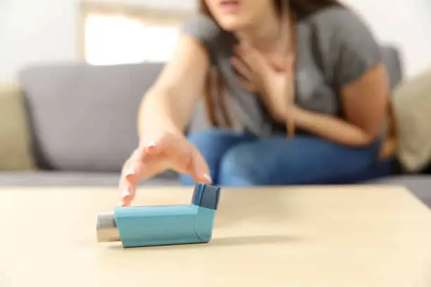 women reaching for the inhalers to help manage her asthma