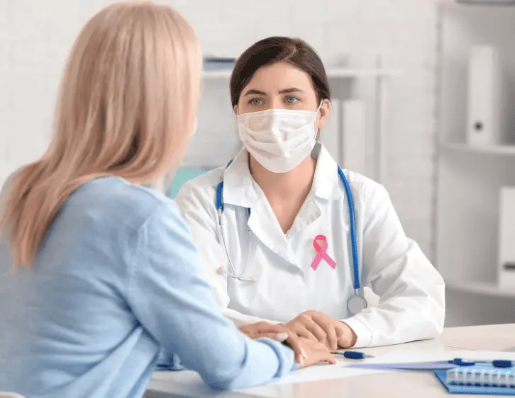 A woman talking to a female doctor