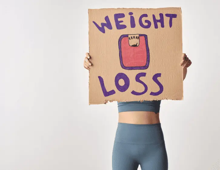 A woman holding a signage with the text weight loss